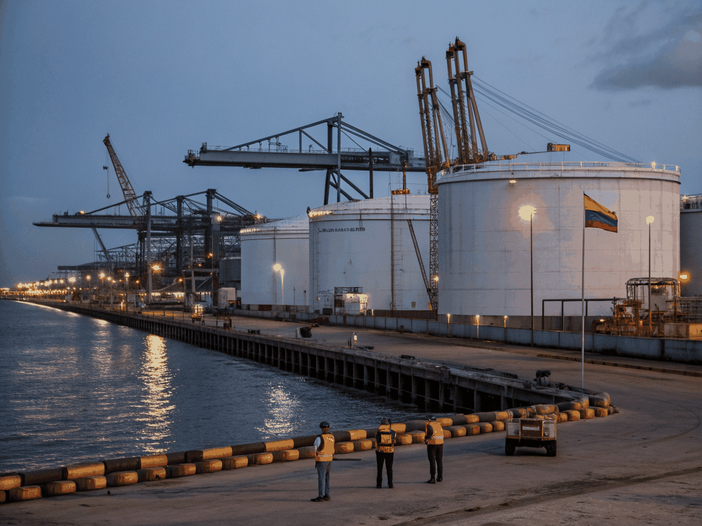 Marine tanker vessel berthed at oil terminal loading arm